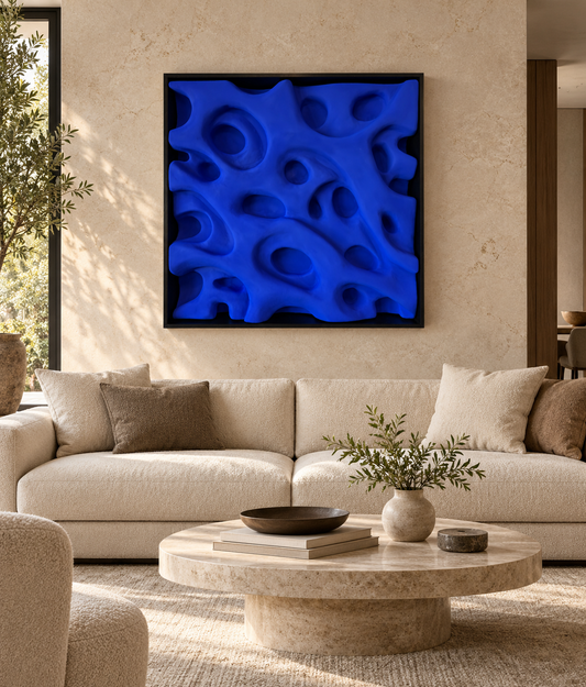 Alt text: Square matte Yves Klein Blue abstract relief artwork with organic recessed shapes in a black shadowbox frame, 105 × 105 cm. 