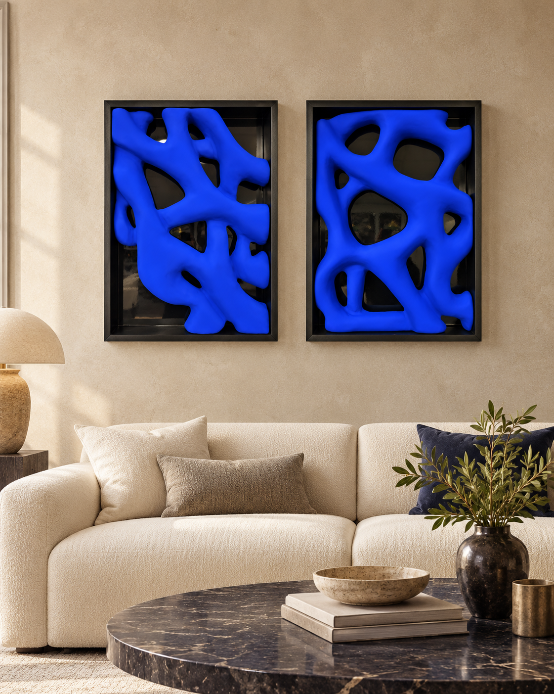 Two matte Yves Klein blue abstract sculptural artworks displayed side by side in matching black shadowbox frames as a 50 × 70 cm diptych.